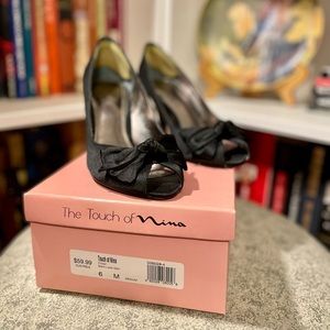 Black satin heels with bow detail